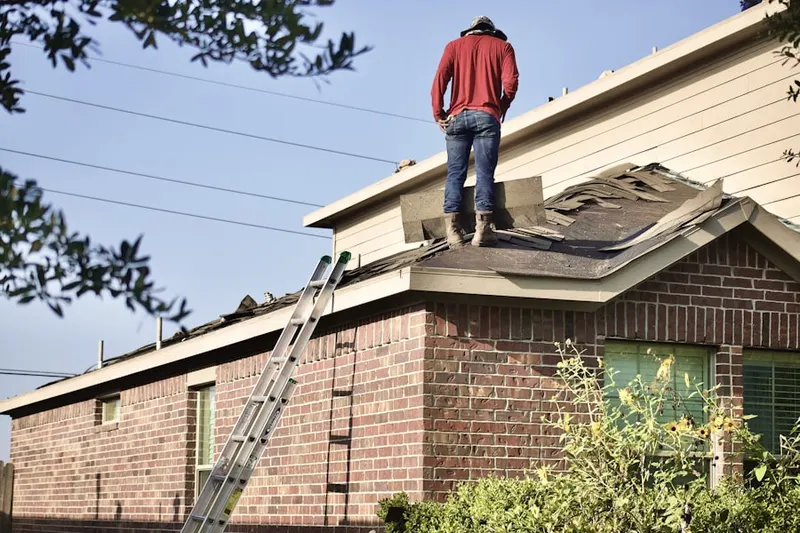 Professional roofer working on a residential roof in Puente Junction